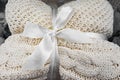 A soft knitted blanket is folded and tied with a white ribbon with a bow. The concept of comfort and coziness. Gift for the holida