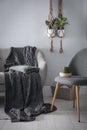 Soft knitted blanket on sofa in room. Home interior Royalty Free Stock Photo