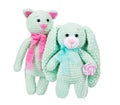 Soft knitted toys and lollipop on white background. Plush crocheted cat with pink scarf.