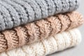 Soft knitted wool textures in gray, beige, and cream stacked together, showcasing intricate patterns and inviting warmth Royalty Free Stock Photo