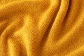Soft knitted yellow sweater texture closeup. Light orange abstract background Royalty Free Stock Photo