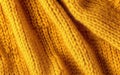 Soft knitted yellow sweater texture closeup. Light orange abstract background Royalty Free Stock Photo
