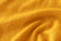 Soft knitted yellow sweater texture closeup. Light orange abstract background Royalty Free Stock Photo