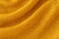 Soft knitted yellow sweater texture closeup. Light orange abstract background Royalty Free Stock Photo