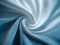 Soft light blue fabric twisted in a delicate swirl pattern showcasing smooth texture and elegant flowing lines for artistic and Royalty Free Stock Photo