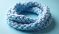 Soft light blue knitted loop accessory. Cozy chunky yarn texture forms a warm circular pattern. Perfect for winter fashion Royalty Free Stock Photo