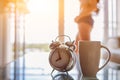 Soft light and Blurred image, alarm clock placed next to bed woke up at set time for woman to wake up and prepare to leave for