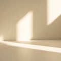 Soft light creates abstract patterns on a beige wall. The shadows are elongated and Royalty Free Stock Photo