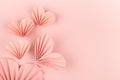 Soft light pastel pink paper hearts of asian fribbed fans soar on pink background, top view. Festive Valentines day, wedding, love
