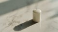 Soft Light and Shadow on a White Candle on Marble Royalty Free Stock Photo