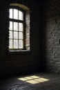 Soft light spills through window on cold brick wall, dim, darkness Royalty Free Stock Photo