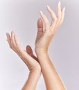 Soft, manicure hands or beauty treatment closeup of female model palms touching in elegant hand pose isolated on purple Royalty Free Stock Photo