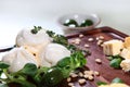 Soft mozzarella cheese on a wooden Board with green olives. Copy of the space. Vertical photo.Top view Royalty Free Stock Photo