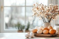 Soft natural light fills a rustic kitchen while a table is covered with Easter egg dyeing supplies, showcasing a Royalty Free Stock Photo
