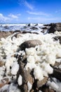 Soft ocean foam on porous rocks