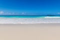 Soft ocean wave on clean sandy beach.