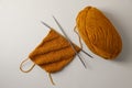 Soft orange yarn, knitting and metal needles on beige background, flat lay Royalty Free Stock Photo