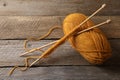 Soft orange yarn, knitting and needles on wooden table, above view Royalty Free Stock Photo