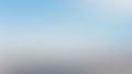 Soft, out-of-focus gradient background transitioning from a pale sky blue to a muted light gray and white Royalty Free Stock Photo