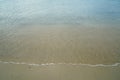 Soft pastel clean sandy beach with fresh clear sea water and white foamy wave line background and copyspace on Ornos shore