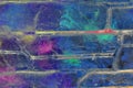 Mixed media artwork, abstract colorful artistic painted layer in blue color palette with purple, green splashes on grunge brick Royalty Free Stock Photo