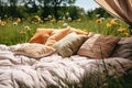 Soft pillows and blanket in a summer dandelion field