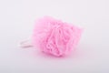 Soft pink bath puff or sponge on white background Royalty Free Stock Photo