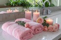 Soft Pink Bath Towels Decorated with Romantic Roses and Candles in a Serene Spa Like Bathroom Environment