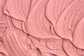 Soft pink cosmetic clay facial mask, cream texture close up, selective focus. Abstract background with brush strokes. Royalty Free Stock Photo