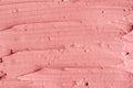 Soft pink cosmetic clay facial mask, cream texture close up, selective focus. Abstract background with brush strokes. Royalty Free Stock Photo