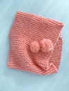 Soft pink lace knitted round scarf isolated on pastel blue background. Fashion children\'s accessory