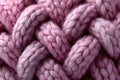 Soft pink woolen threads woven into a cozy cable knit fabric, creating a warm and textured background Royalty Free Stock Photo