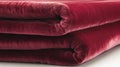 Soft, plush maroon blanket folded neatly on a white background Royalty Free Stock Photo