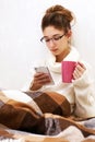 Soft portrait of cute teenage girl with palmtop at home