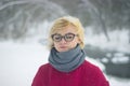 Soft portrait of odd lonely girl sitting in winter snowy forest. Friendless female person with sad emotional