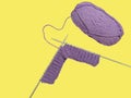 purple ball of yarn and knitting needles on a yellow background, space to insert text Royalty Free Stock Photo