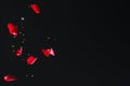 Red Rose Petals Falling in Front of Black Background Royalty Free Stock Photo