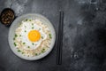 Soft rice and crisp edged fried egg in a rustic bowl photographed on dark textured background for modern culinary Royalty Free Stock Photo