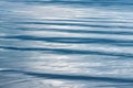 Rippling blue water surface reflecting light during midday at a tranquil lake Royalty Free Stock Photo