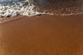 Soft sea wave rolls onto sandy beach. Red Sea. Copy space Royalty Free Stock Photo