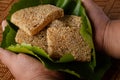 Soft sesame dessert in lotus leaf and there is a hand holding Thai desserts