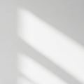 Soft shadows of parallel lines on a white surface create an abstract, minimalist Royalty Free Stock Photo