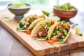 soft shell beef tacos with salsa and guac on wooden board Royalty Free Stock Photo
