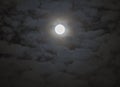 Soft shining full moon surrounded by moody fantasy-like clouds, Royalty Free Stock Photo