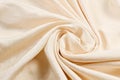Soft smooth beige silk fabric background. Fabric texture