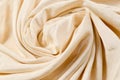 Soft smooth beige silk fabric background. Fabric texture