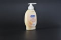 Soft soap moisturizing hand wash side view black background isolated milk and golden honey