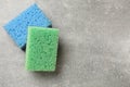 Soft sponges with foam on gray textured table, top view. Space for text Royalty Free Stock Photo
