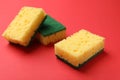 Soft sponges on red background. Cleaning tool Royalty Free Stock Photo