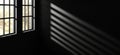 soft spotlight shines on wall, creating abstract pattern of shadows from windows. interplay of light and dark evokes sense of calm Royalty Free Stock Photo